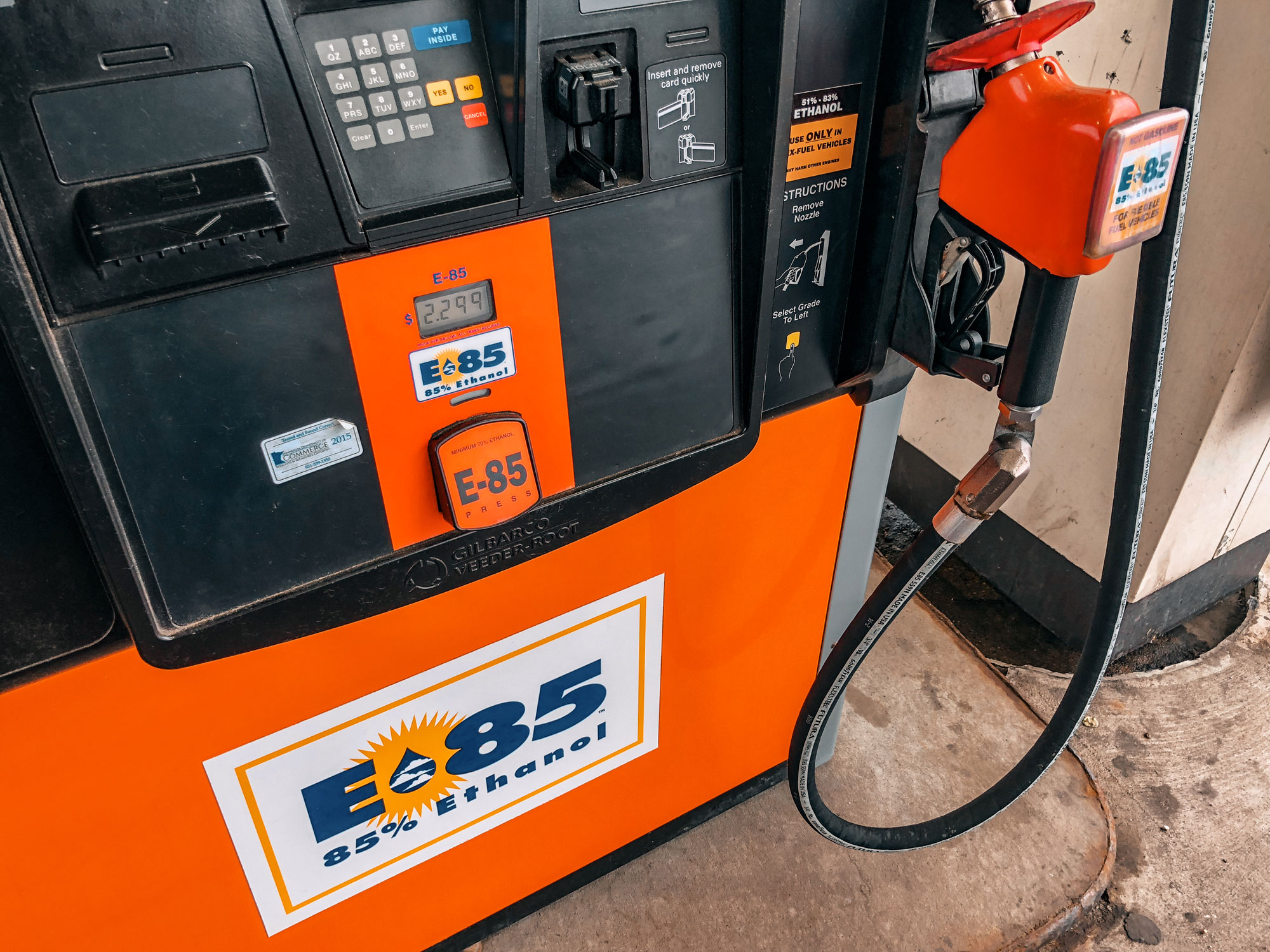 Photograph of an E85 fuel pump in Minnesota. The photo shows an orange and black fuel pump cleared marked "E85, 85% Ethanol" in several places.