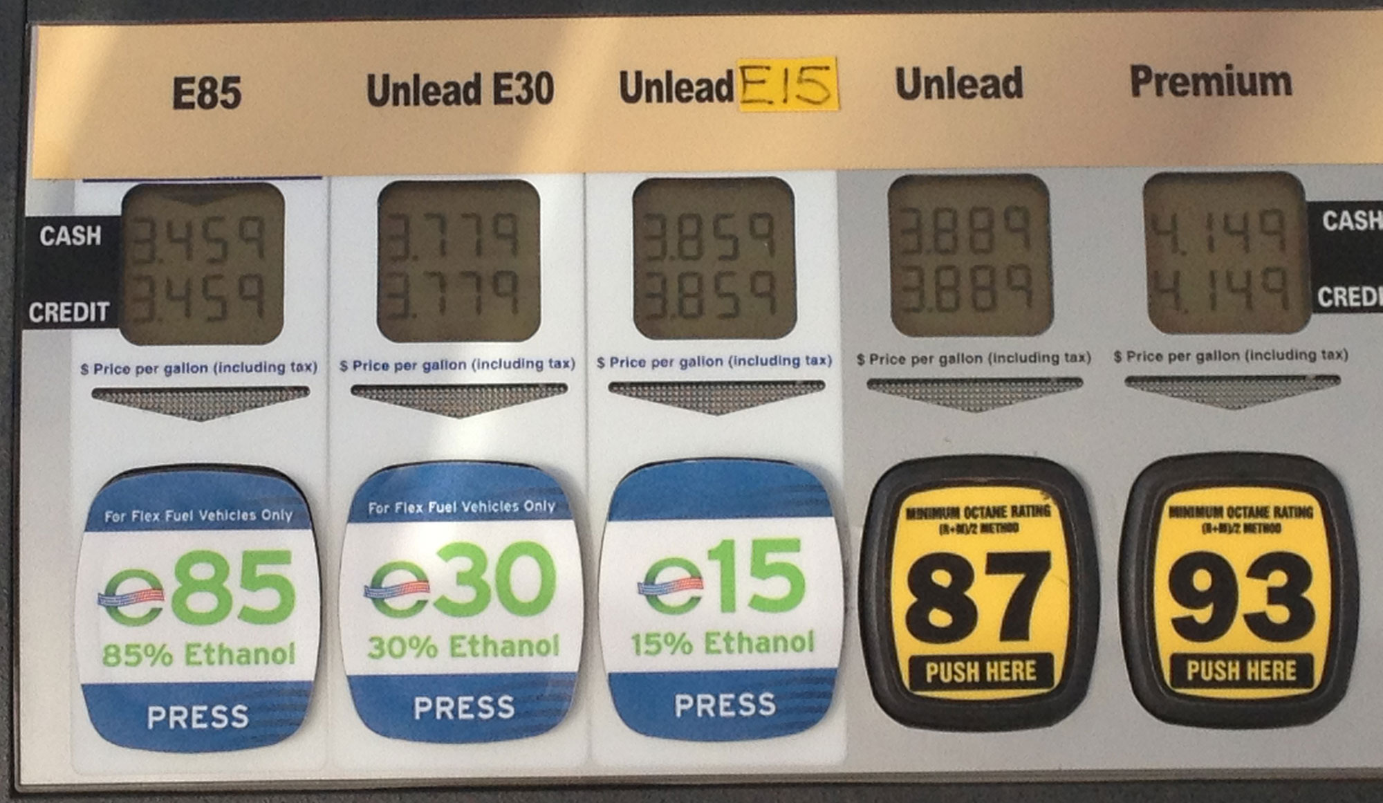 Photograph of fuel selection buttons on a gas pump. The options are E85 (85% ethanol), E30 (30% ethanol), E15 (15% ethanol), unleaded, and premium.