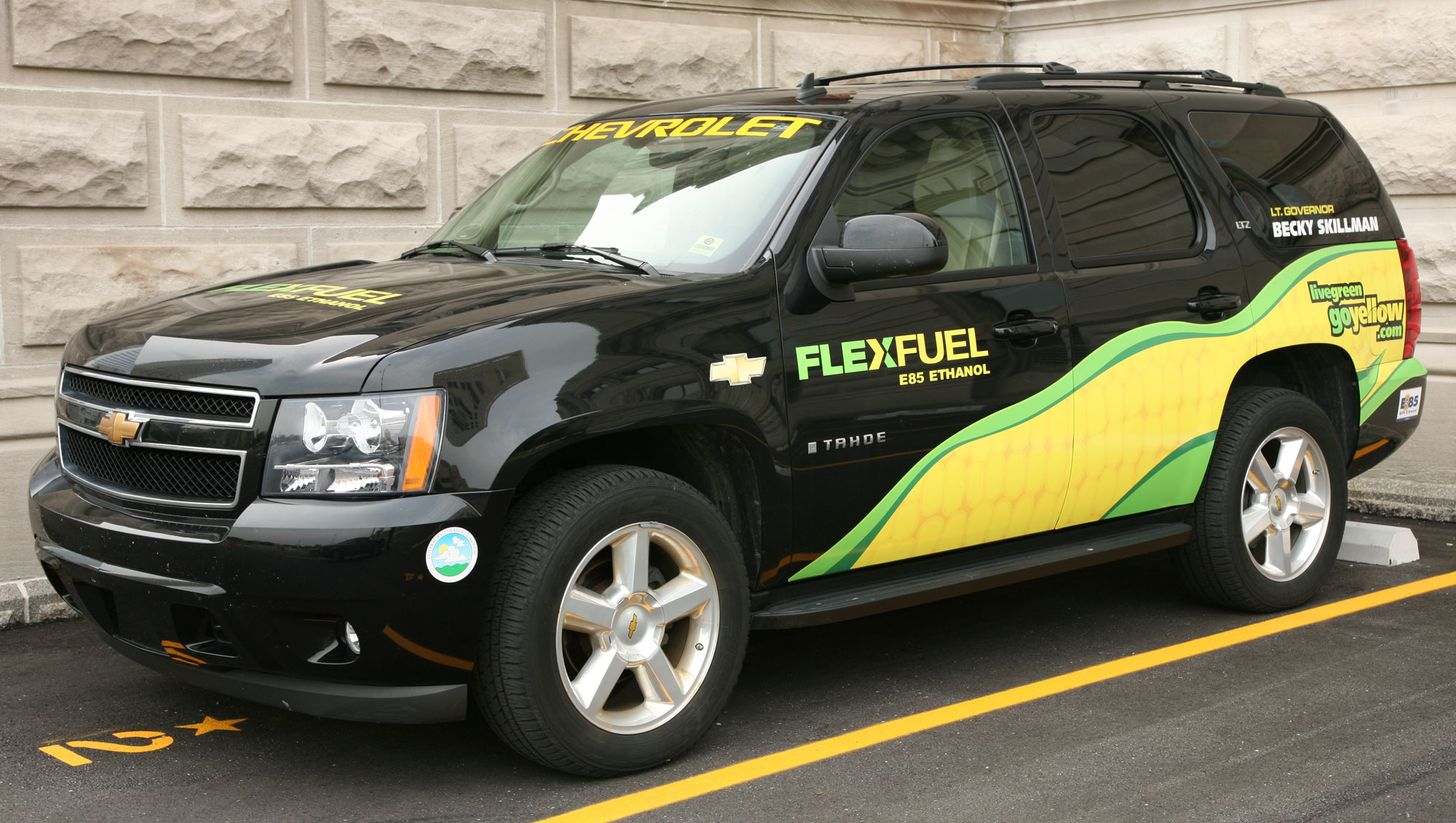Photograph of an SUV that can run on E85 fuel The photo shows a black Chevy Tahoe with a stylized ear of maize painted on the side. It says "Flexfuel E85 Ethanol" on the side, as well as "livegreengoyellow.com." 