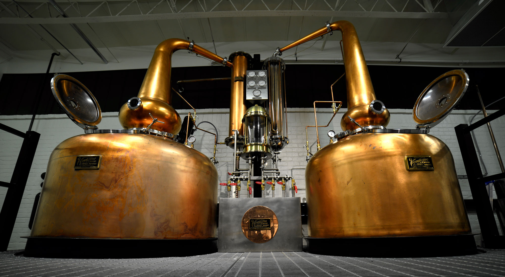 Photograph of two large copper stills at a bourbon distillery in Atlanta, Georgia, USA.
