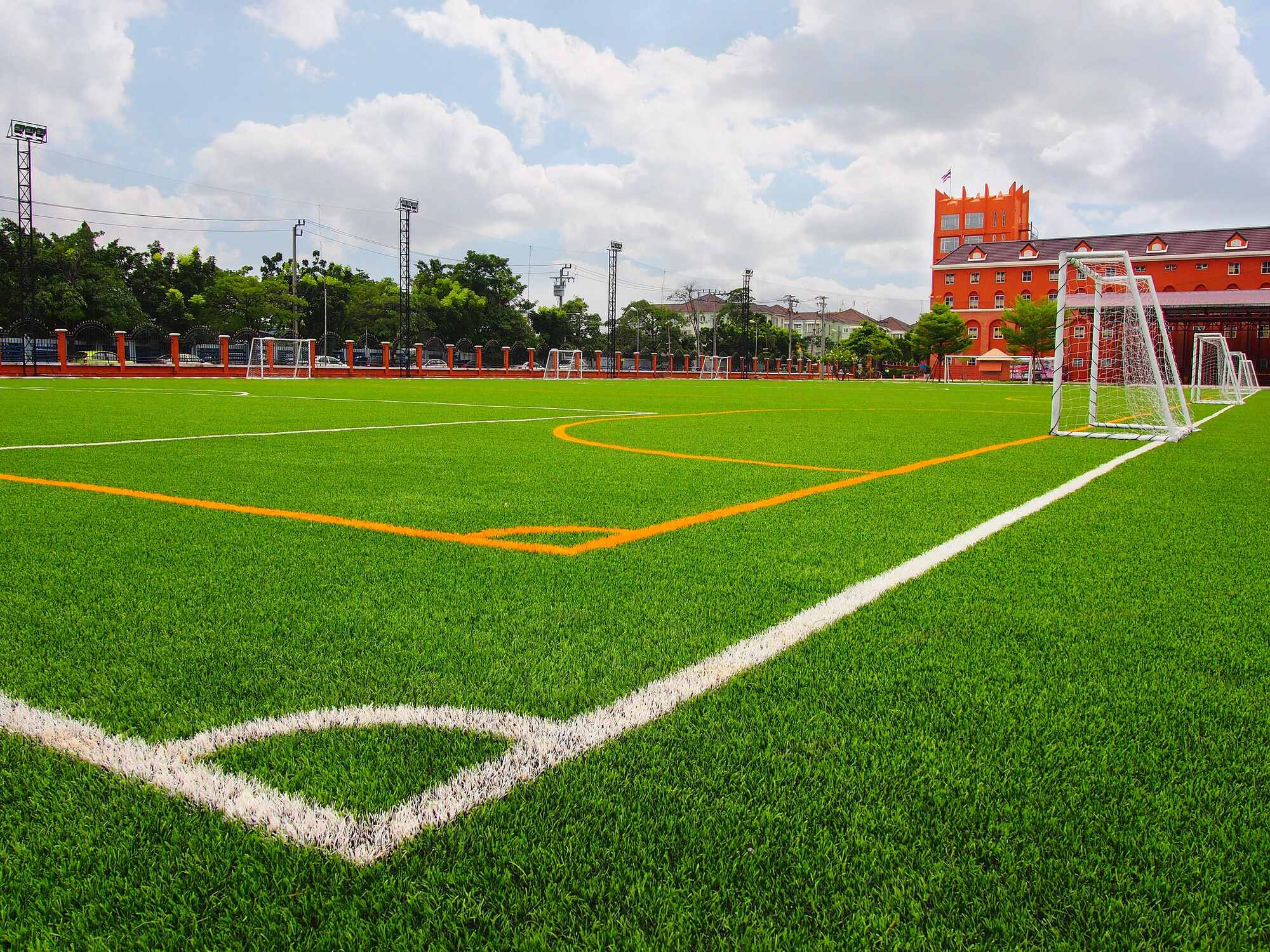 Photograph of a turf soccer field outside of a high school.