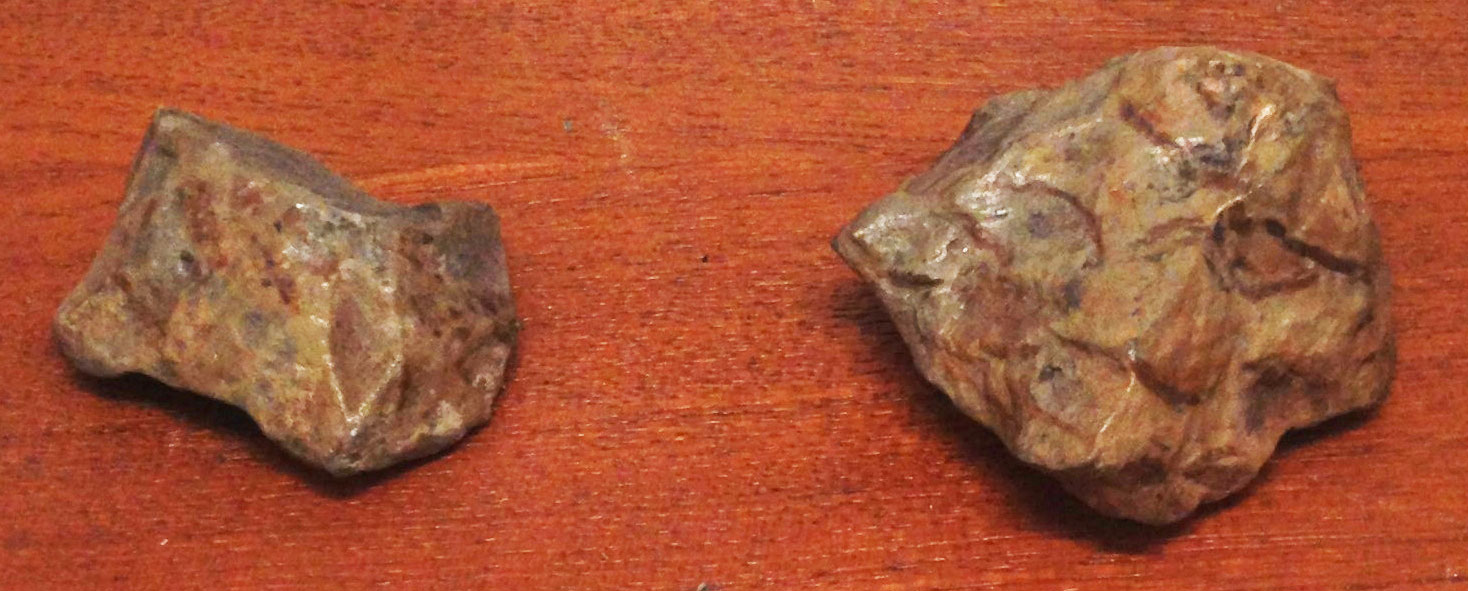 Photograph showing replicas of stone tools attributed to Homo erectus from Yunnan, China. The photo shows two irregularly shaped stones.