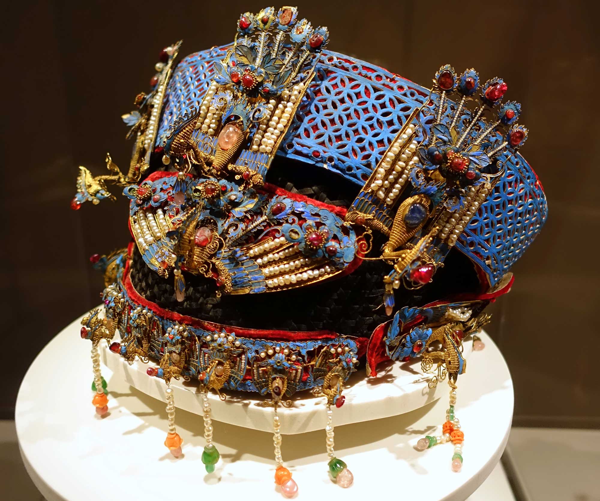 An elaborate Chinese noblewoman's phoenix crown dating to the late 1800s and inlaid with blue kingfisher feathers.