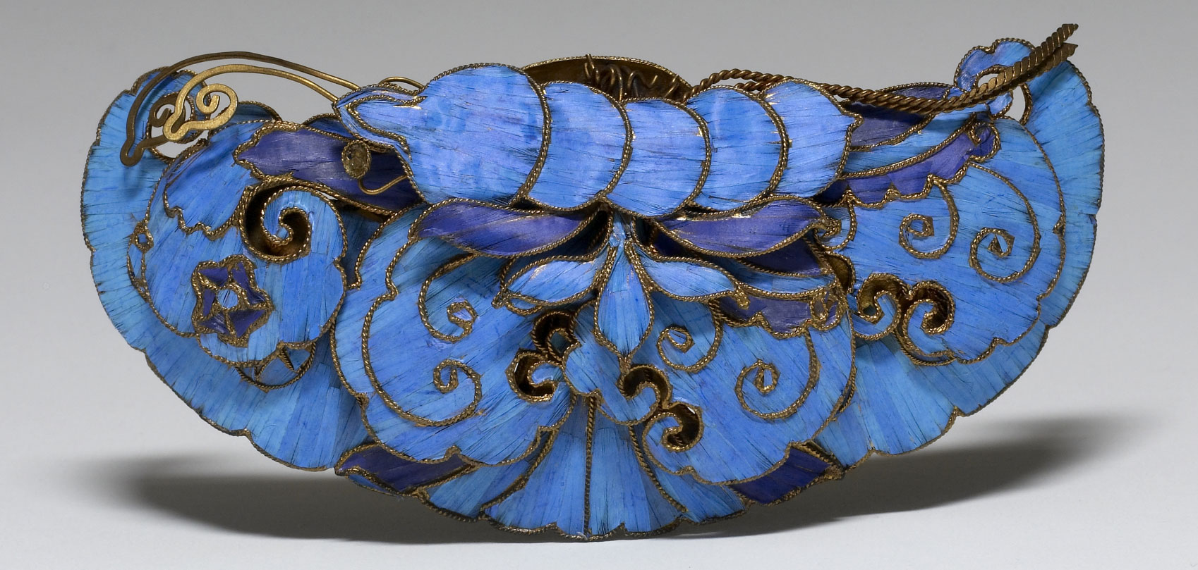 A Chinese hair ornament from about 1800 to 1900 inlaid with blue kingfisher feathers.